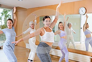 Dynamic young woman practicing belly-dance