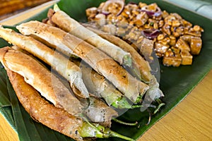 Dynamite lumpia and Tofu in peanut garlic sauce. Philippine appetizers or food usually served with beer photo