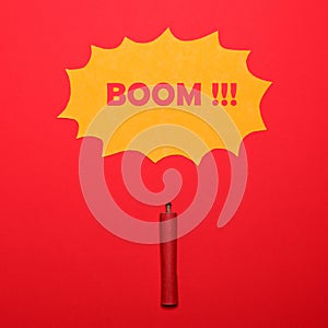 Dynamite stick with BOOM sign above on red background - Explosion concept - Minimal design