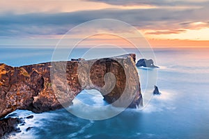 Dyrholaey rock formation at sunset photo