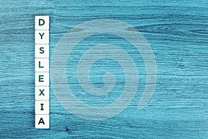 Dyslexia concept, word on blue desk