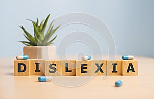 Dyslexia Word Written In Wooden Cube, dislexia concept. photo