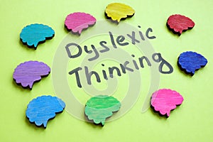 Dyslexic thinking sign and colorful brains around. photo