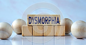 DYSMORPHIA - word on wooden cubes on a light background with balls