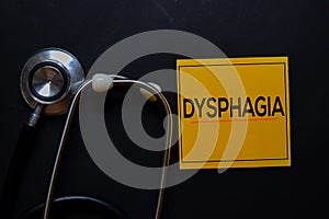 Dysphagia text on sticky notes. Top view isolated on black background. Healthcare/Medical concept photo