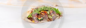 DÃÂ¶ner Kebab Doner Kebap slice fast food in flatbread on a wooden board panorama photo