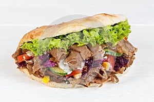 DÃÂ¶ner Kebab Doner Kebap slice fast food in flatbread on a wooden board photo