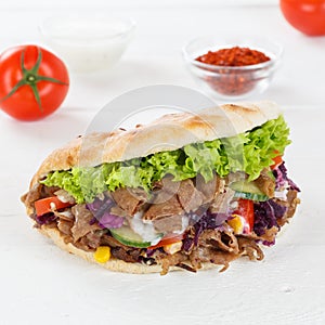 DÃ¶ner Kebab Doner Kebap fast food in flatbread on a wooden board square