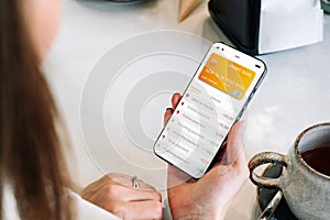 E banking concept. Girl holding mobile phone with internet online bank app. Credit card wallet application. Online