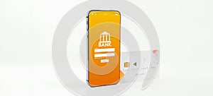 E banking concept. Mobile phone with internet online bank app. Credit card on white background. Online wallet save money