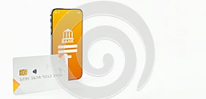 E banking concept. Mobile phone with internet online bank app. Credit card on white background. Online wallet save money