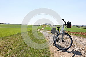 E-bike on the sandy road against the blue sky in spring