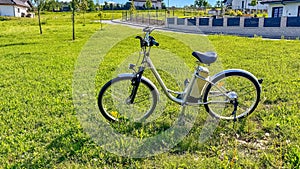 The e-bike stands on the green grass in the park