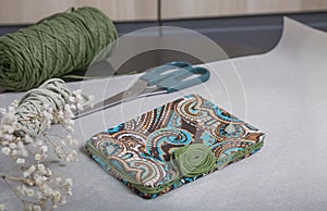 An e-book case decorated with fabric and braid. Handmade work. Individual order