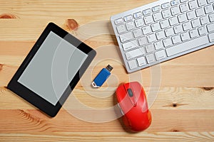 E-book reader with blank screen and keyboard and mouse and flash drives USB. on wooden floor, Used modern gadgets or electronic