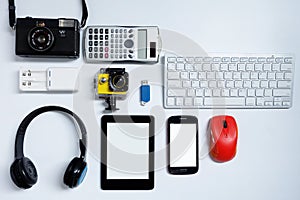 E-book reader with cell phones, camera, keyboard, mouse and flash drives USB. on white background, Used modern gadgets or electron