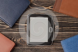 E-book reader close-up on wooden background