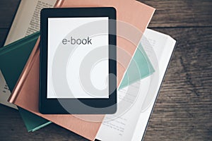 E-book reader on a stack of books