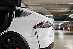 E-car being refilled with energy at underground parking lot