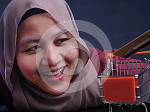 E-commerce Concept, Muslim Lady Holding Mini Trolley and Credit Card