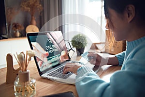E-commerce and online shopping concept, Woman hand using laptop Mockup website and holding credit card