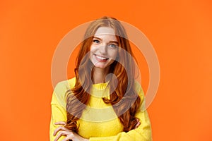 E-commerce, professionalism and employement concept. Cheerful pleasant redhead curly-haired woman in yellow sweater