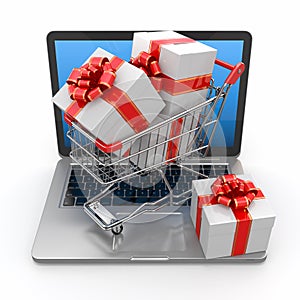 E-commerce. Shopping cart and gifts on laptop