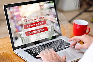 E-coupon, Grocery shopping online, Woman hand using laptop computer entering the discount coupon code on screen, online shopping