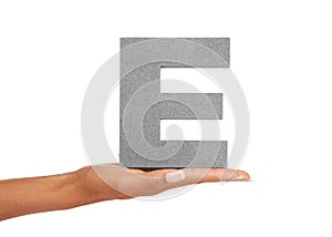 E is for Enterprising. A young woman holding a capital letter E isolated on a white background.