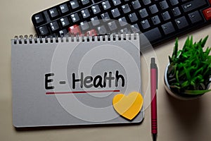 E-Health write on a book isolated on office desk photo