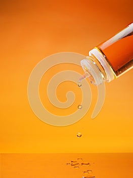 e-juice dripping. e-liquid , vape liquid dripping on orange yellow background, good for advertise.