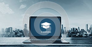 E-learning on computer laptop and city background. Online education, e-learning and e-book concept