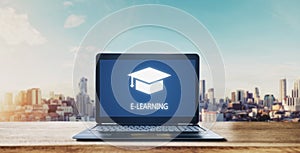 E-learning on computer laptop and city sunrise background. Online education, e-learning and e-book concept