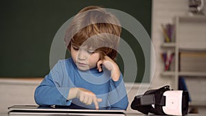 E-learning online education concept. Kid with tablet for homework. Child using digital laptop. Home schooling.