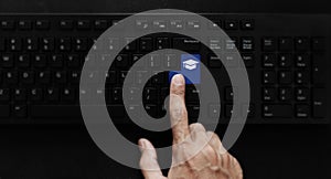 E-learning, online education and online studying course. Hand pressing education icon on computer keyboard