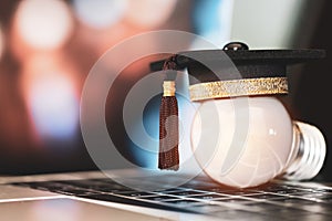 E-learning online graduate education concept : Congratulations graduates on laptop computer blur light background. Elearning can