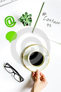 E-mail contact us concept with internet icons and coffee work desk background top view