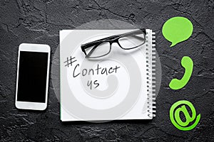 E-mail contact us concept with internet icons and mobile on work desk background top view mockup