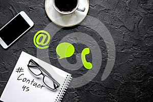 E-mail contact us concept with internet icons and mobile on work desk background top view mockup