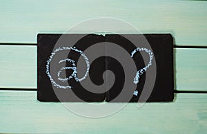 E-mail sign and question mark on blue wooden background,