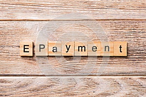 E-payment word written on wood block. E-payment text on wooden table for your desing, concept