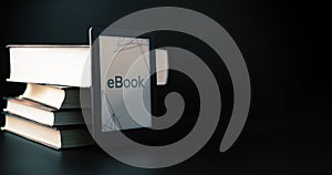 E reader. Digital e book, library reader tablet with books on dark background. Online education course, E learning class
