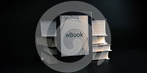 E reader. Digital e book, library reader tablet with books on dark background. Online education course, E learning class