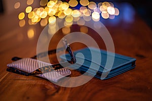 Electronic reader and Reading Glasses with case on a wooden table .