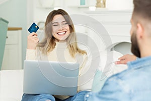 E-shopping. Happy Couple Using Credit Card, Surfing Internet