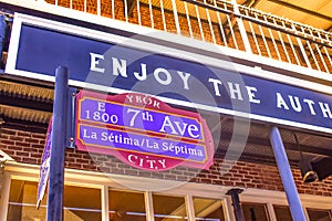 E 1800 7th Ave La Septima sign on vintage building background.