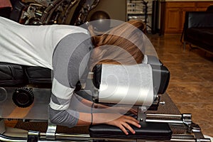 Side View of a Girl Laying on a Tilted Chiropractic Table photo