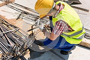 Reliable worker checking the quality of the steel bars photo