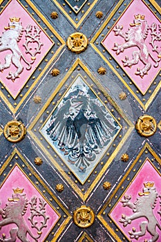 Eagle - coat of arms of Silesia and lion - coat of arms of Bohemia on doors of St. Peter and St. Paul Basilica in Vysehrad, Prague