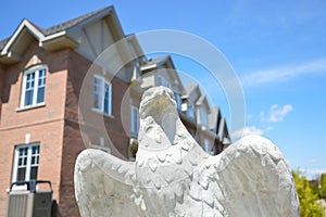 The eagle statue in front of the expensive buildings